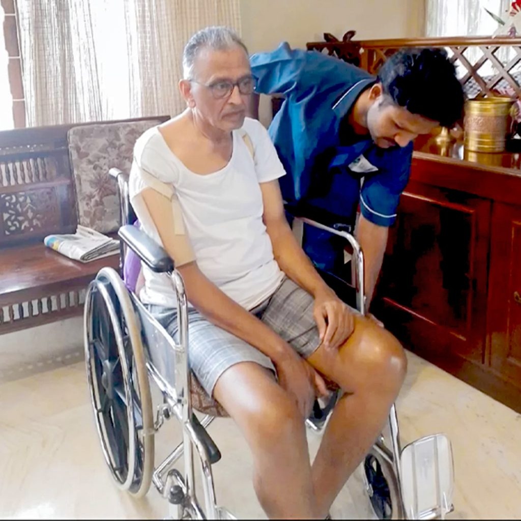Attendant assisting wheelchair patient mobility